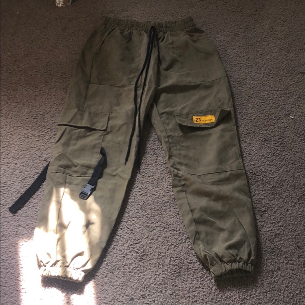 Olive green baggy pants, grip at ankles